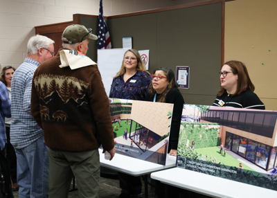Community members observing the renovations concept images.