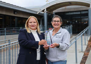 Library Director Kelley Siegrist and Development Director Sherri Vaughn holding the 2025 GFACC award.